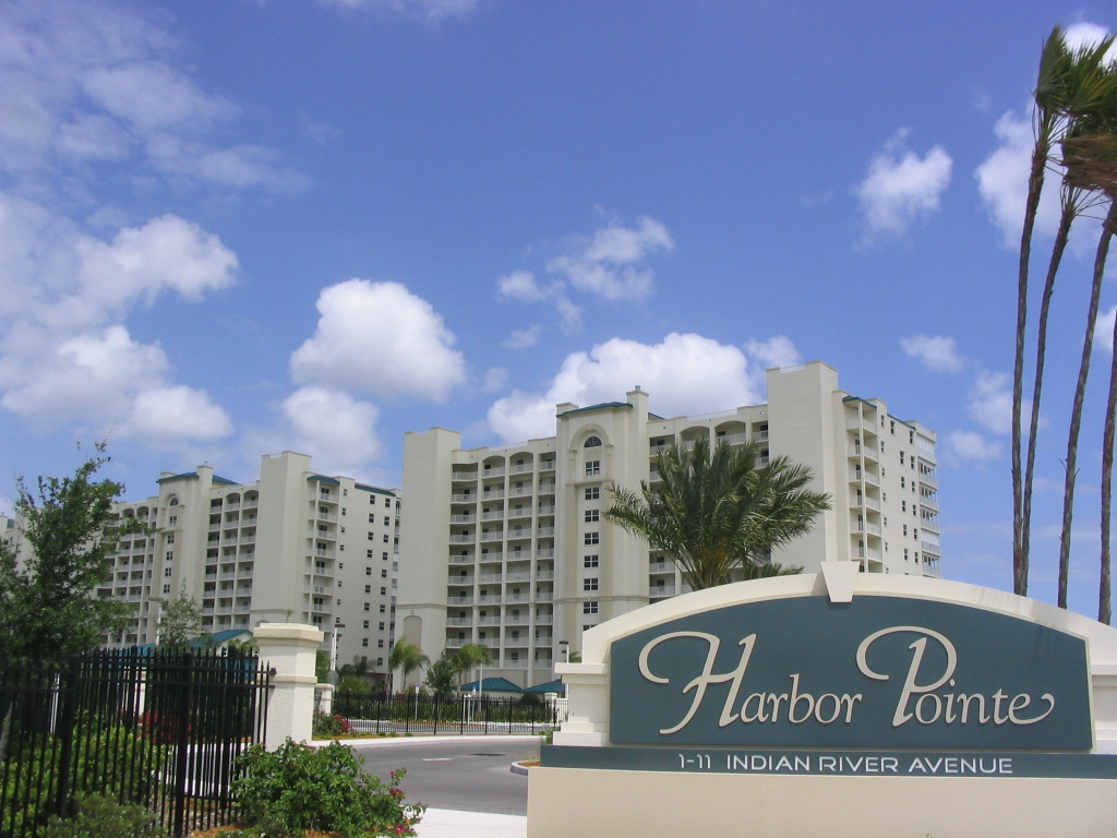 Harbor Pointe Monument Sign in Front of community buildings with blue sky in background